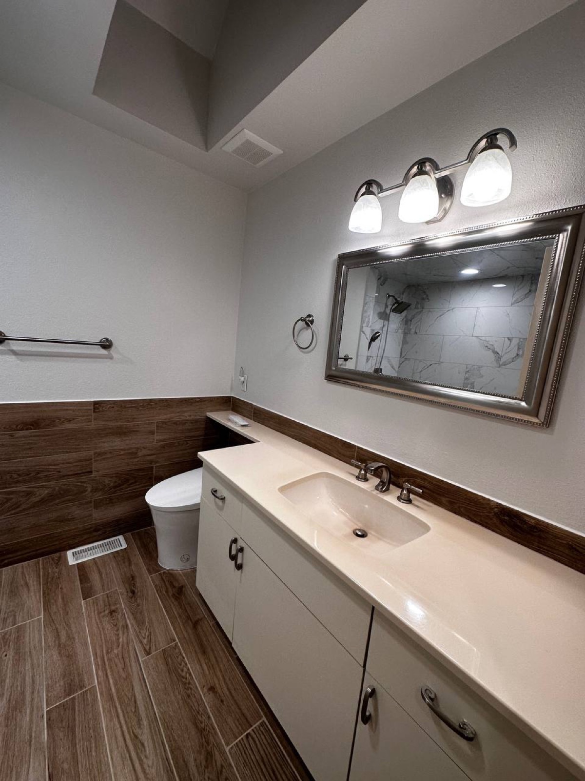 Completed bathroom remodel — vanity and wood-look tile, The Woodlands TX