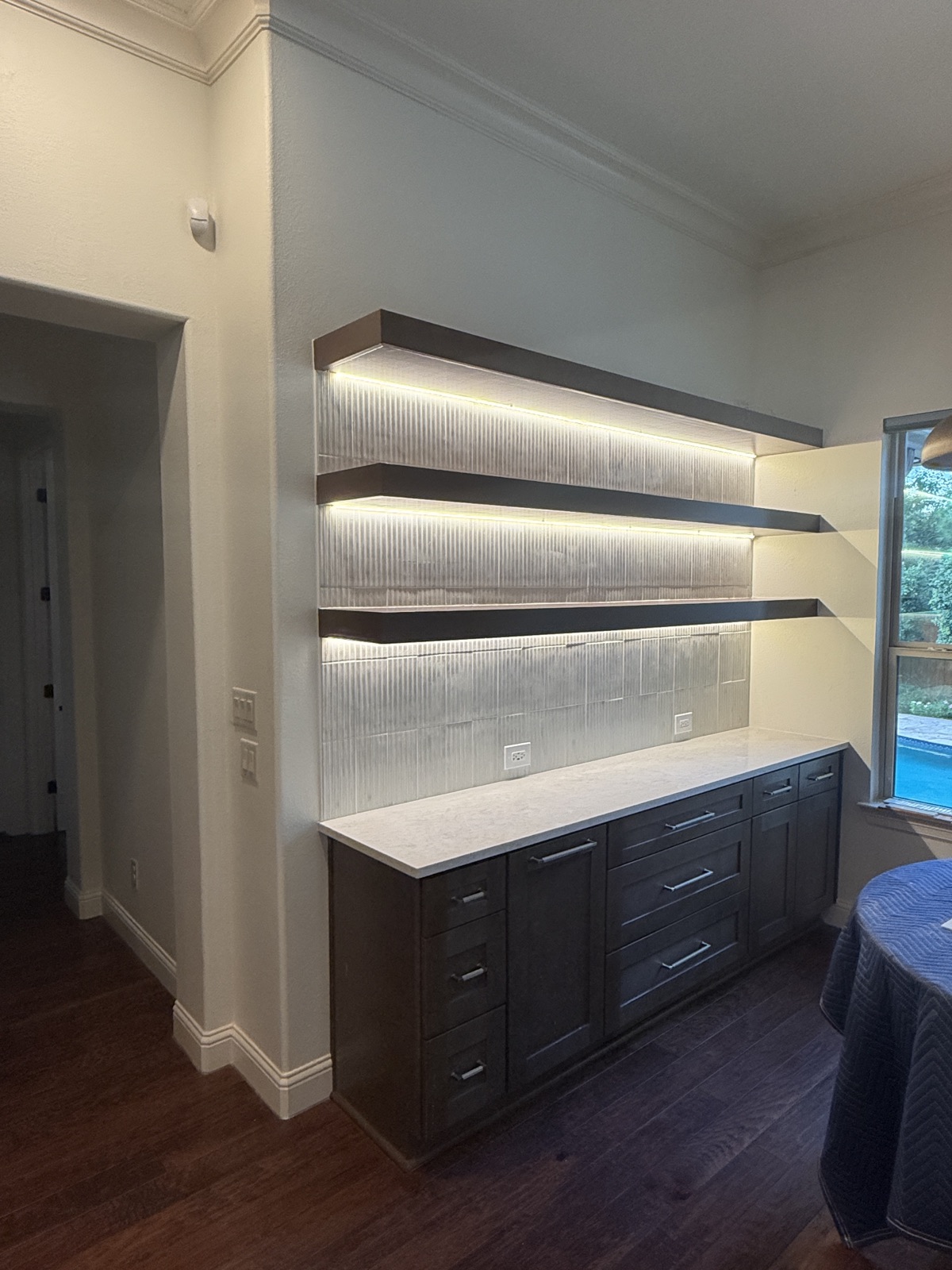 Buffet wall after — custom built-in with LED floating shelves