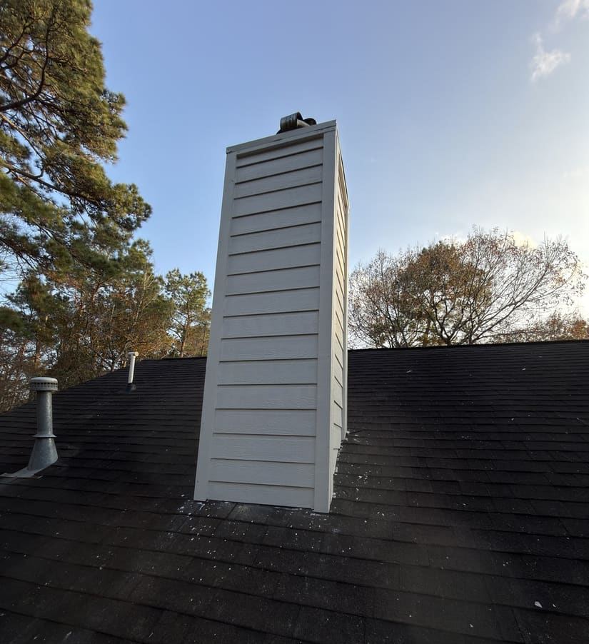 Chimney rebuilt with new HardiePlank siding after wood rot repair