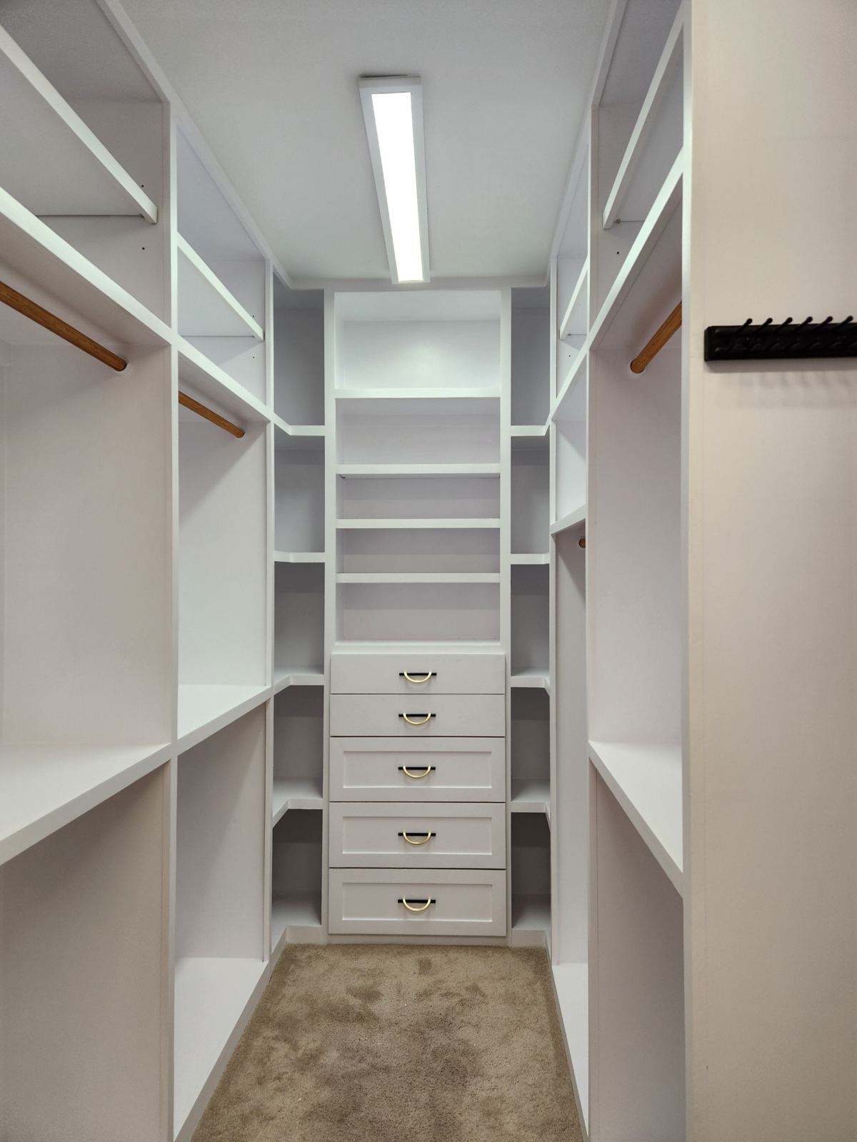 Custom walk-in closet system — built-in shelving and drawer bank