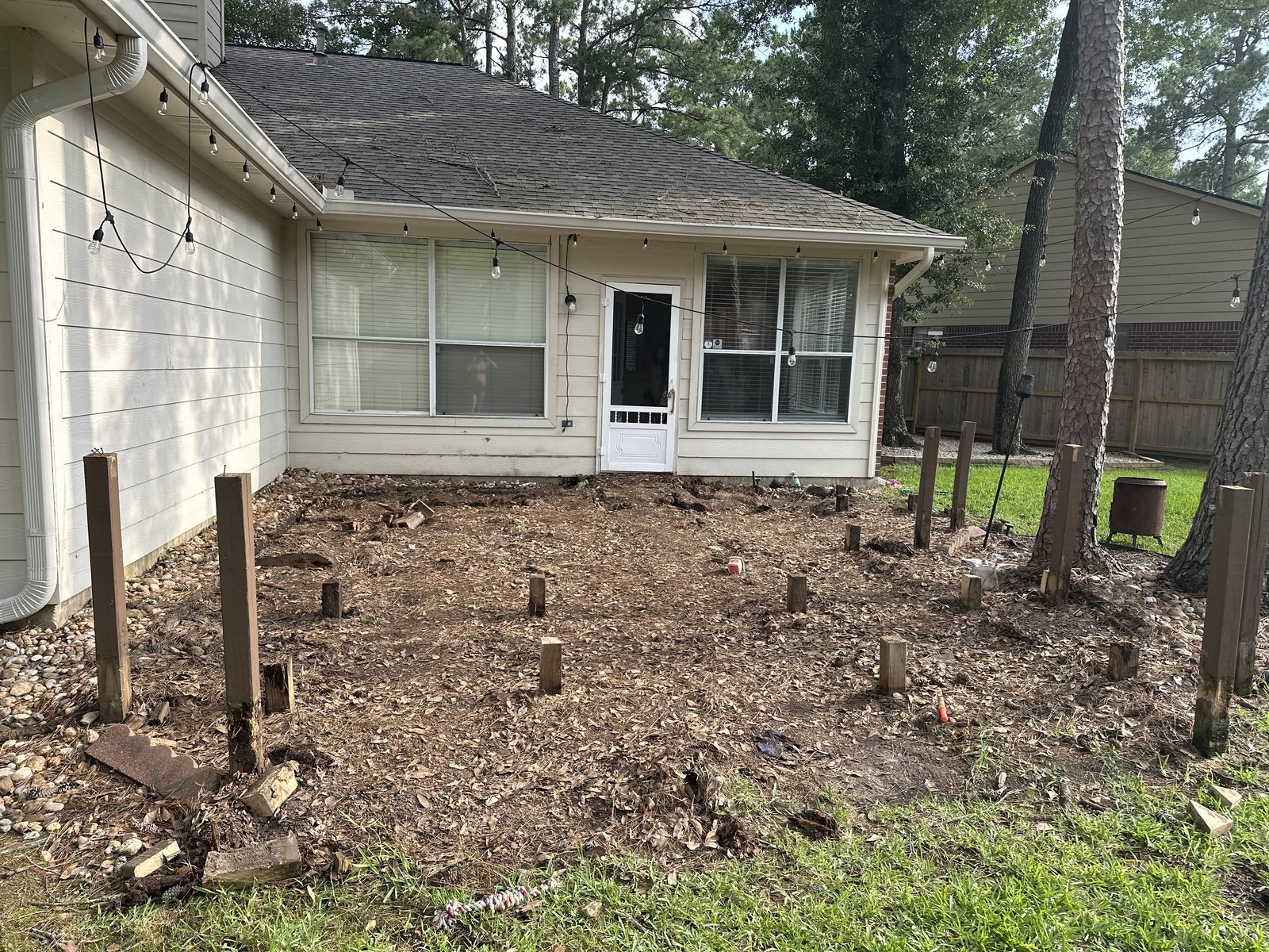 Old deck demolition — original boards removed, framing exposed