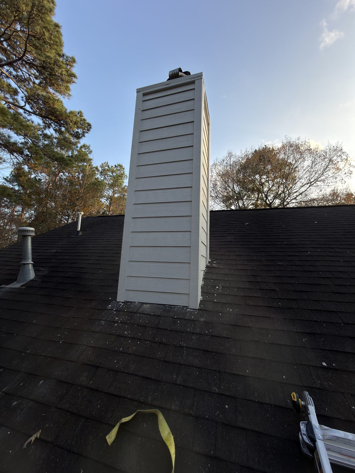 Exterior chimney with new white siding