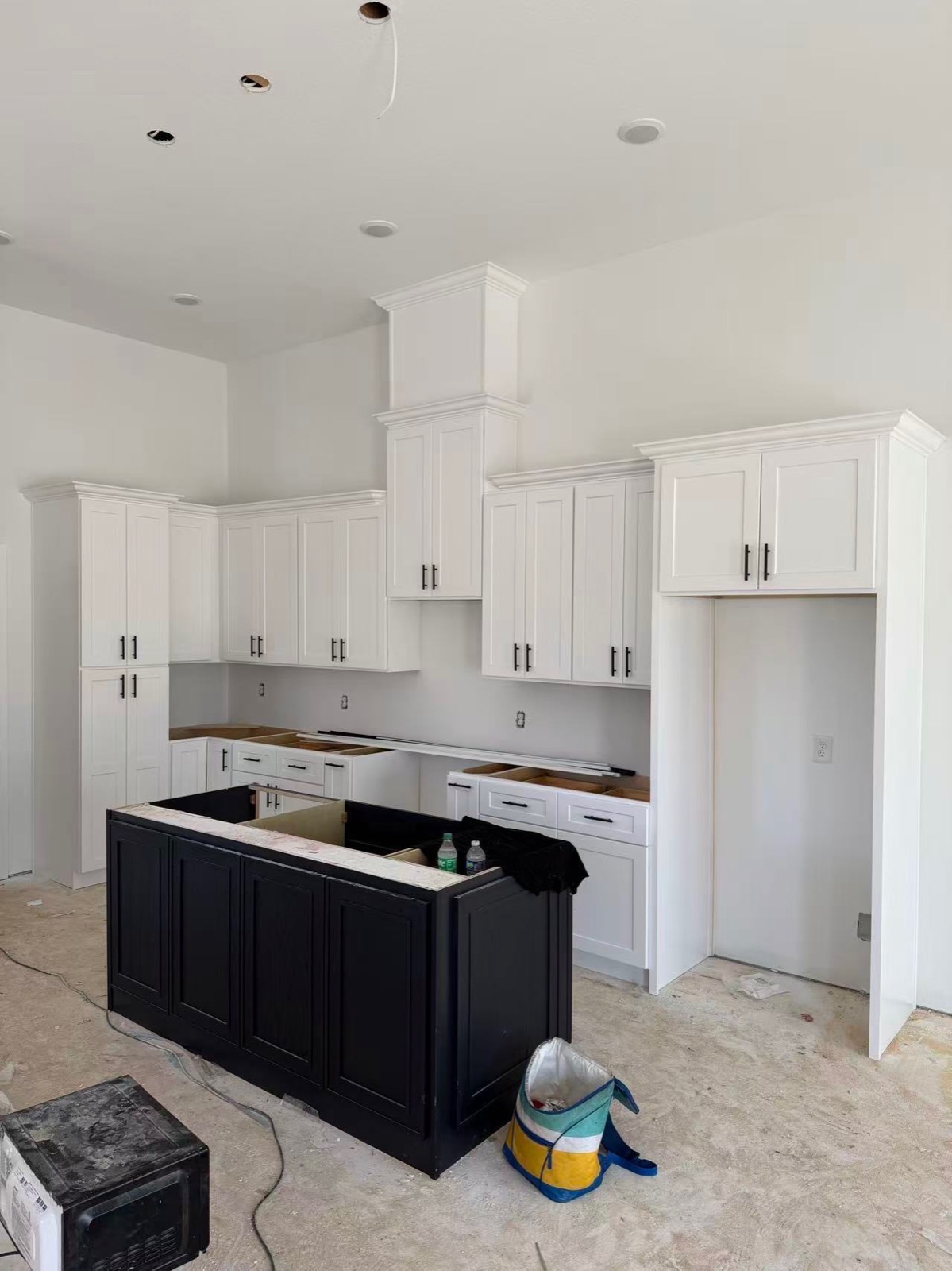 White kitchen with black island — in progress