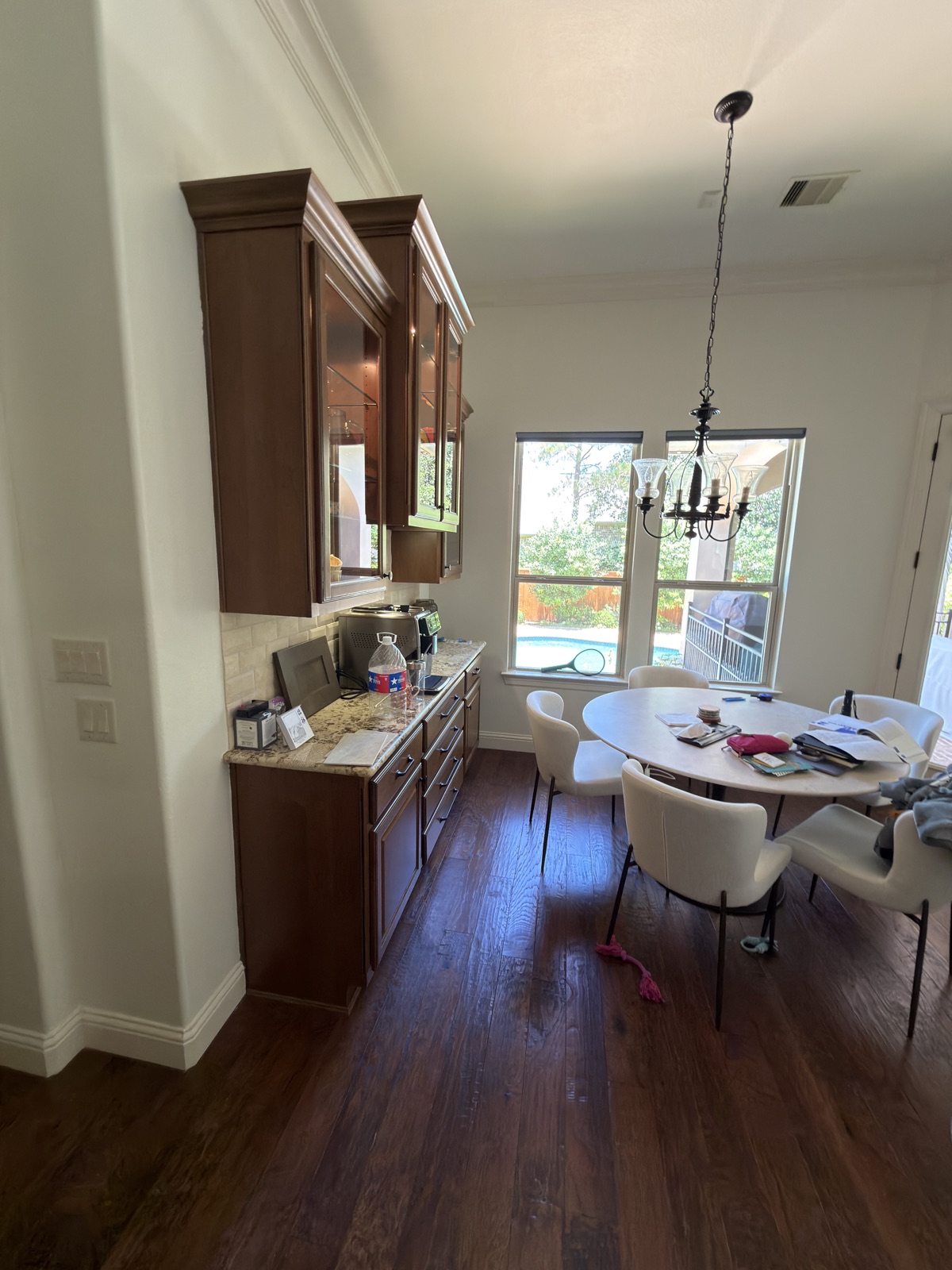 Buffet wall before — dated glass-front cabinets