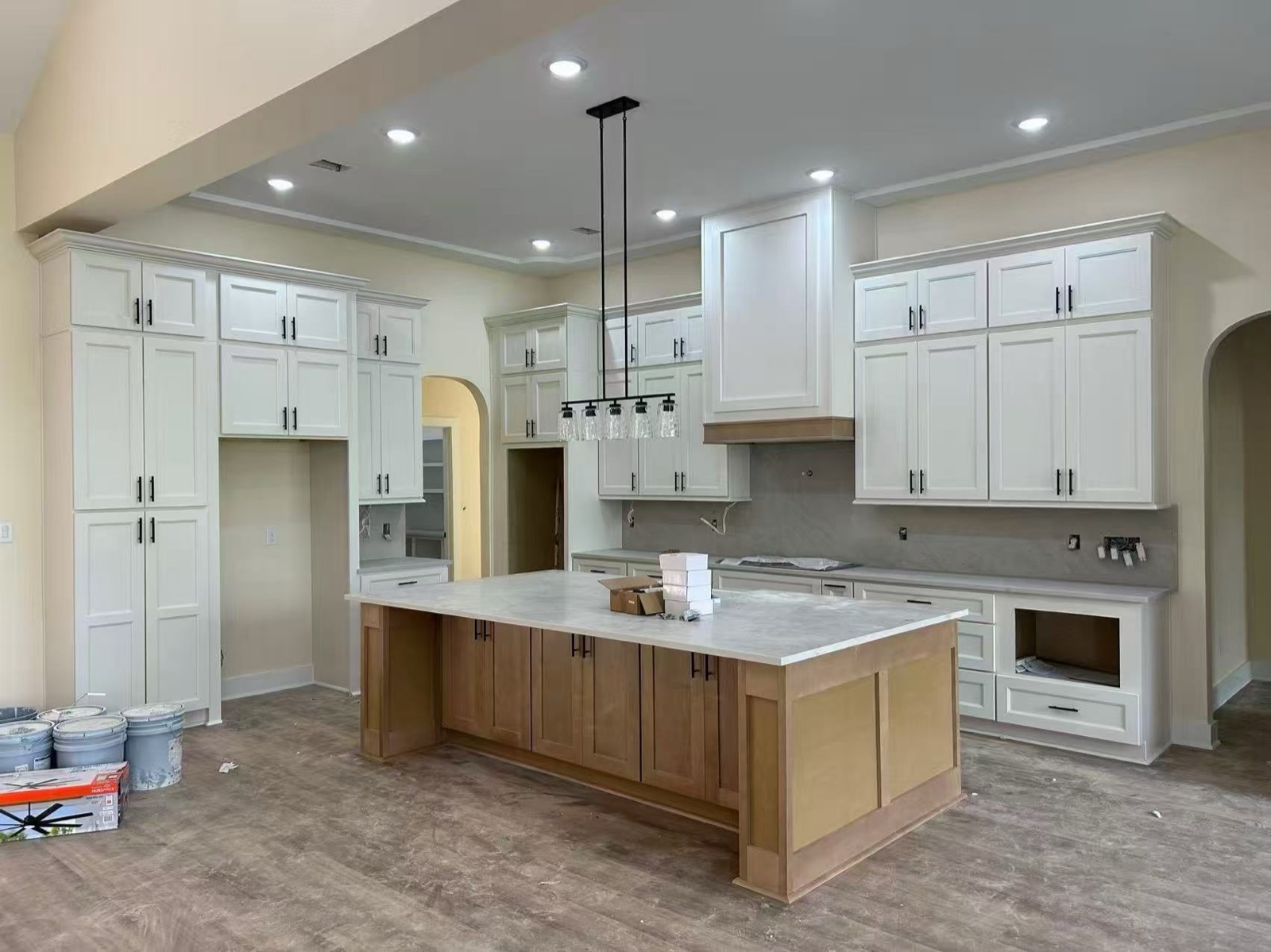 White kitchen with wood island — install in progress
