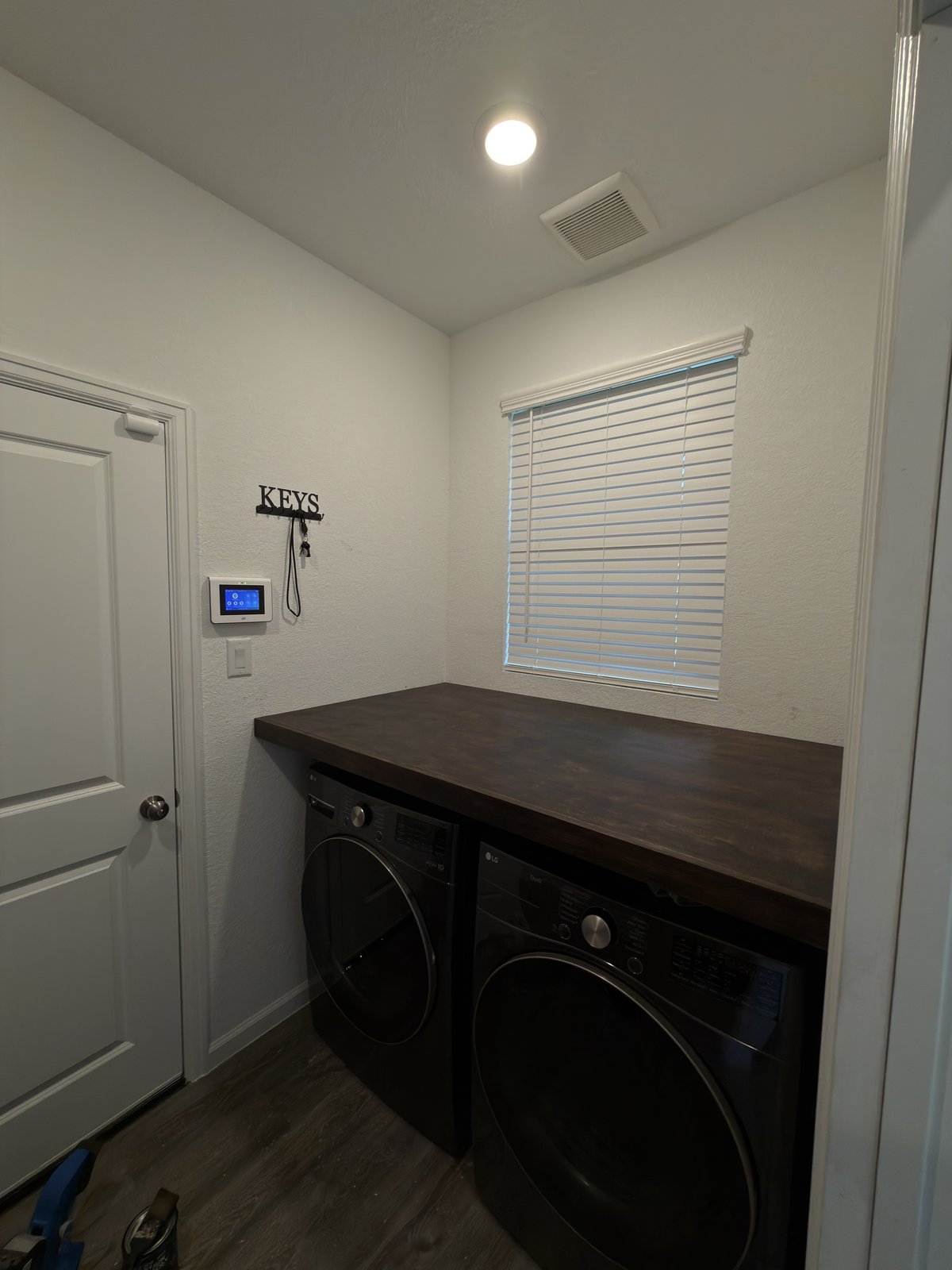 Custom laundry countertop with dark wood top — finished built-in carpentry The Woodlands TX