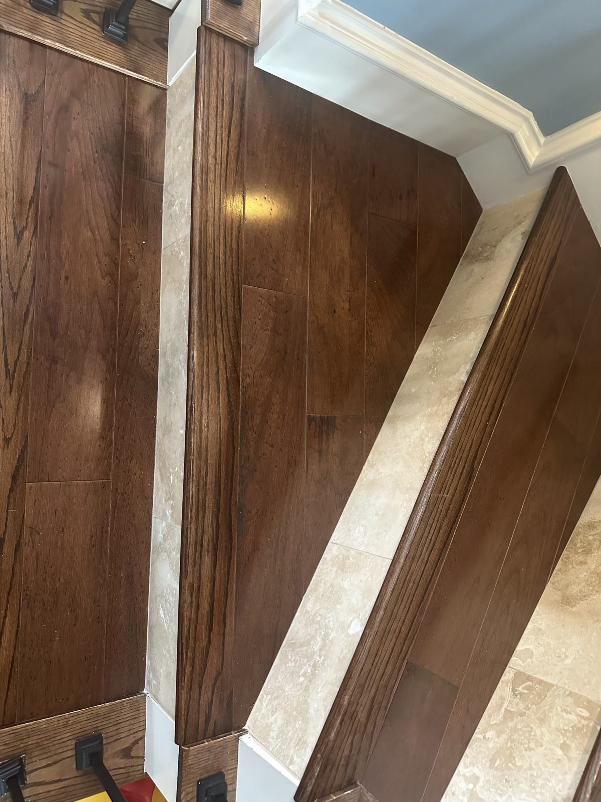 Hardwood stairs with travertine risers